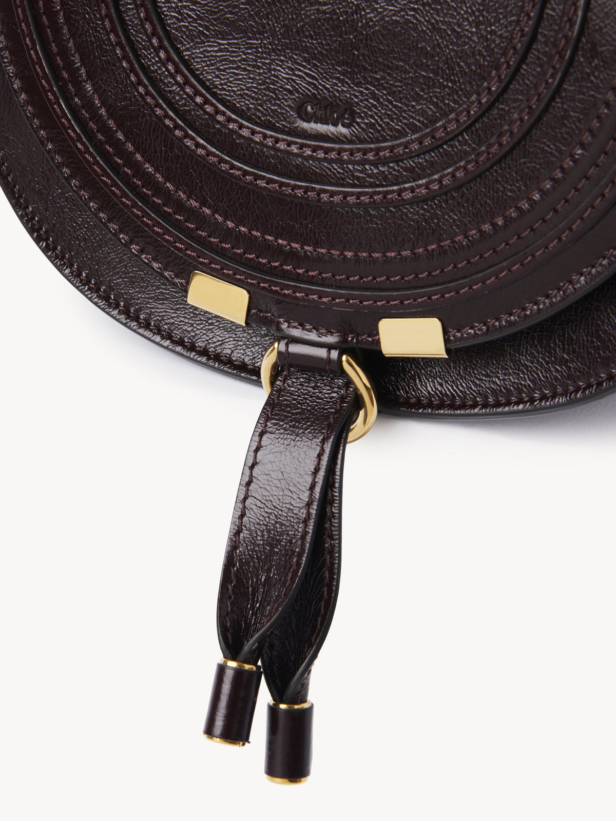 Marcie small saddle bag in shiny leather