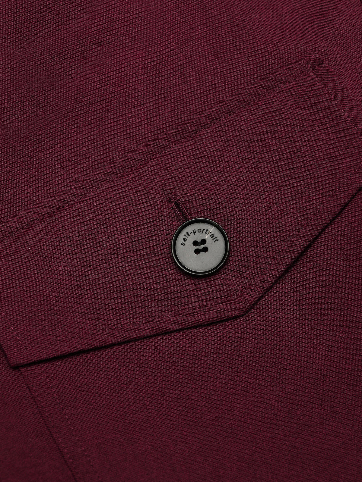 Tutina corta in twill con fiocco al collo