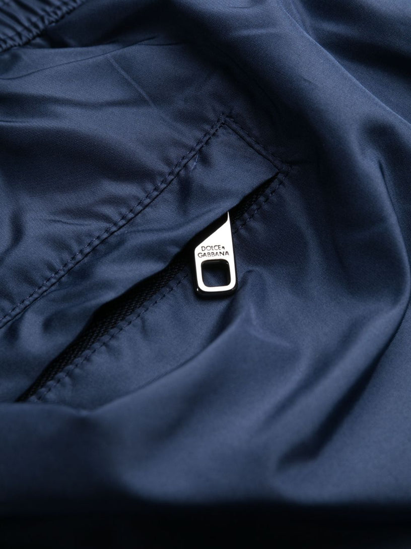 Mid-length swim trunks with branded plate