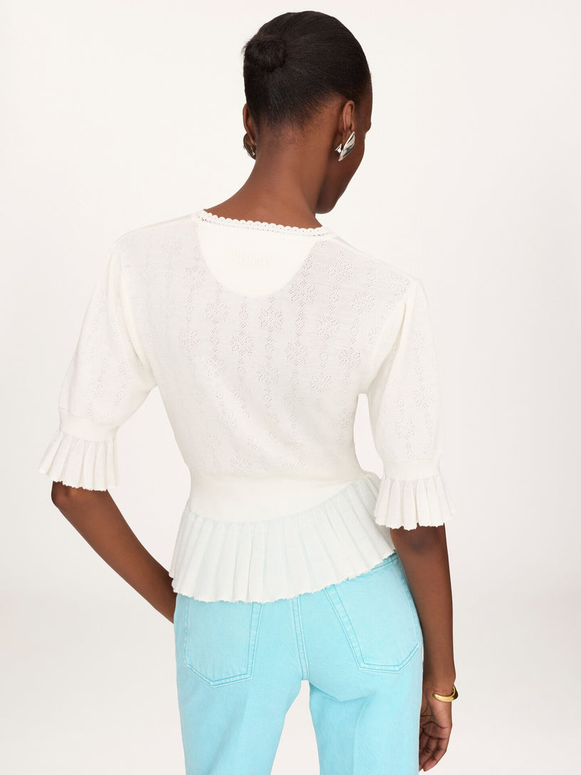 Short wool knit sweater with ruffles