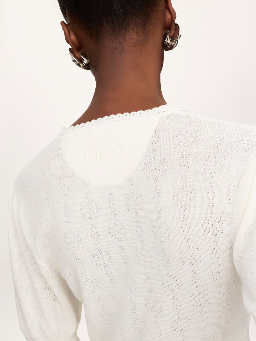 Short wool knit sweater with ruffles